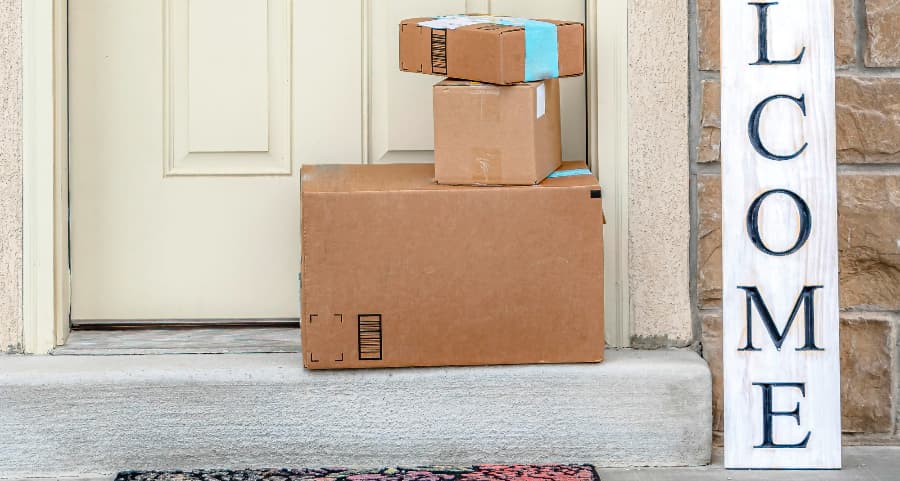 Deliveries on the front porch of a house with a welcome sign in Lincoln